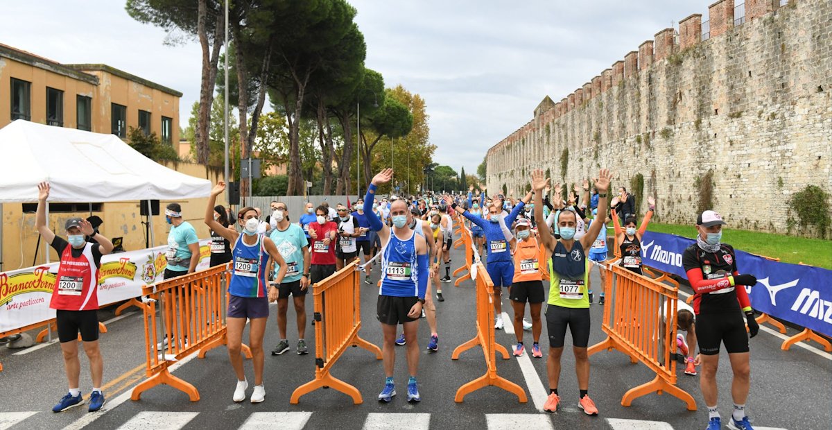 Start of the Pisa Half Marathon with athletes practicing social distancing during the pandemic in 2020